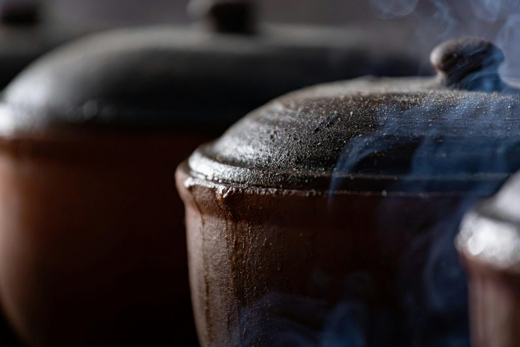 Close-up of steaming clay pots capturing traditional Vietnamese cooking in Thành phố Nam Định.
